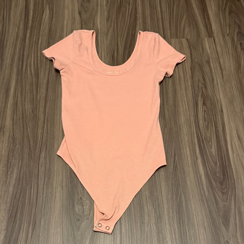 Pink woman’s body suit